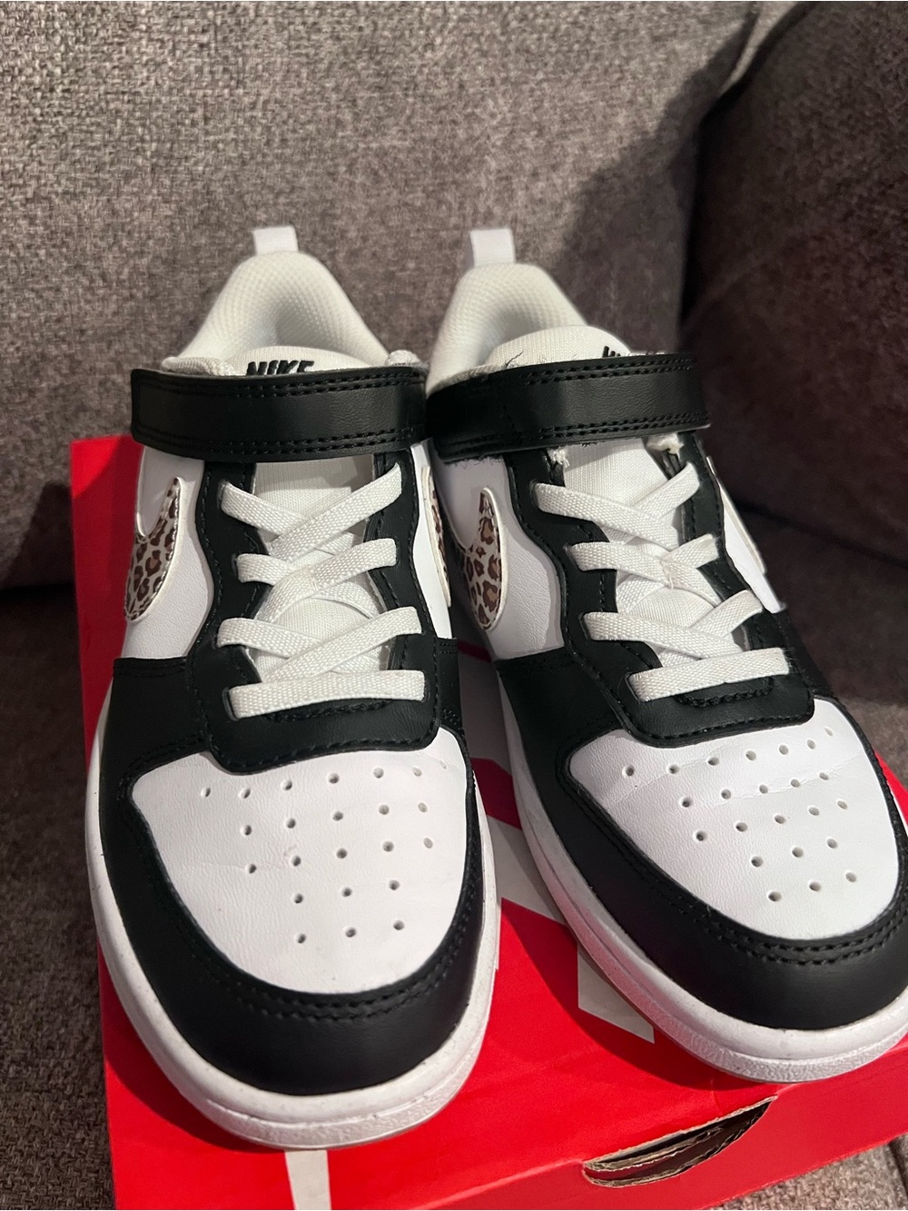 Black and white Nike sneakers with leopard check